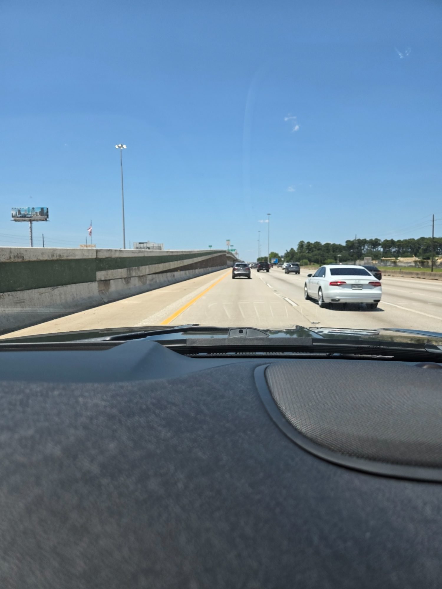 Open Texas highway from the driver's seat, headed out of Houston